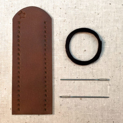 Saddle tan leather lever wrap with baseball stitch